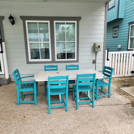 a view of a chairs and table in backyard of the house