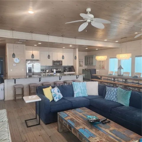 a living room with furniture and kitchen view