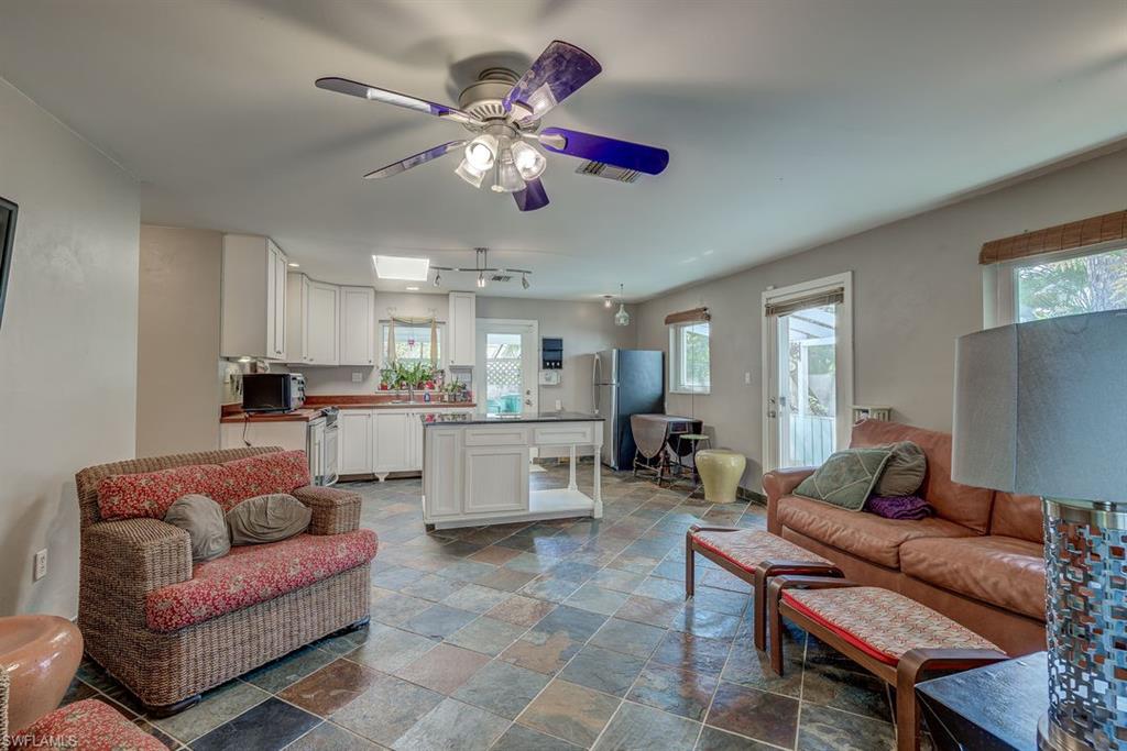9144 7th Street North Naples, FL 34108 - Photo 11 of 20 a living room with furniture kitchen view and a chandelier