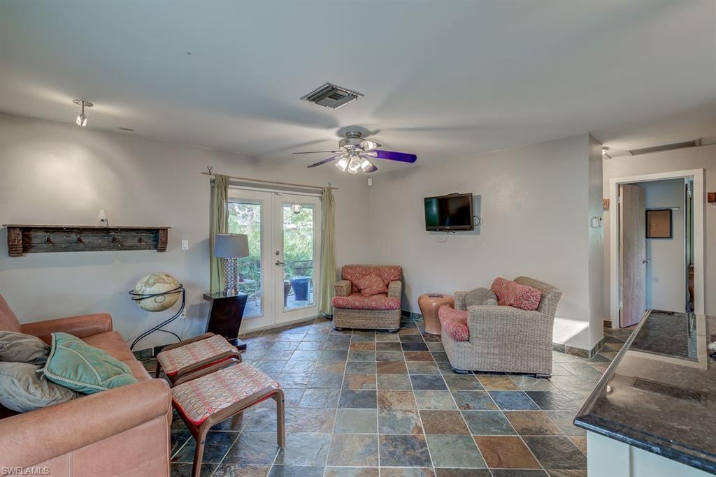 9144 7th Street North Naples, FL 34108 - Photo 17 of 20 a living room with furniture and a chandelier