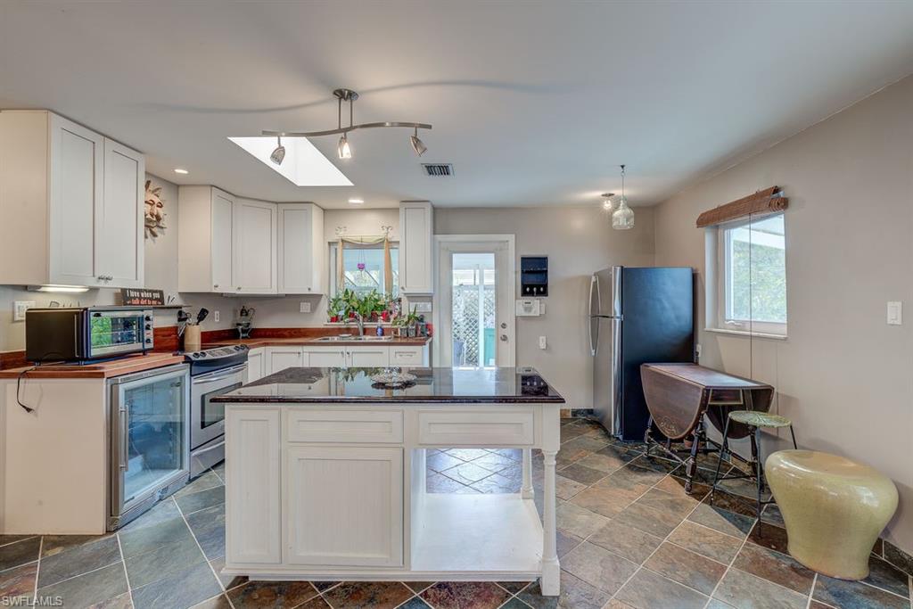 9144 7th Street North Naples, FL 34108 - Photo 2 of 20 a kitchen with a sink cabinets and window