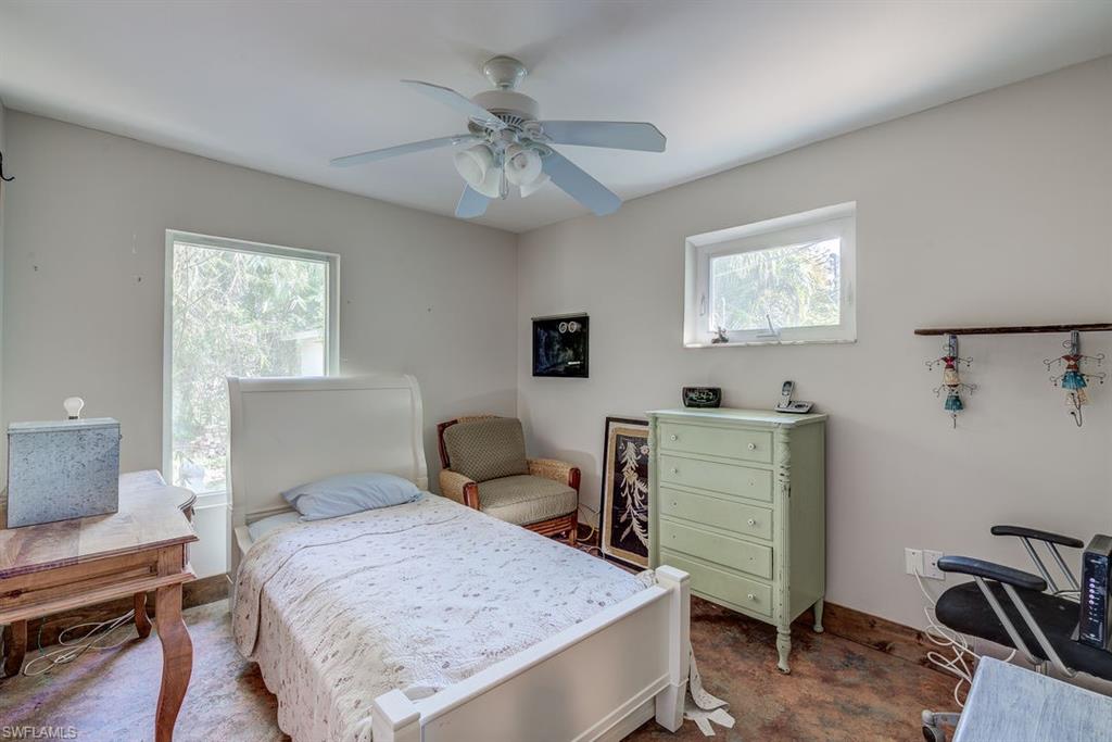 9144 7th Street North Naples, FL 34108 - Photo 9 of 20 a bedroom with a bed and furniture