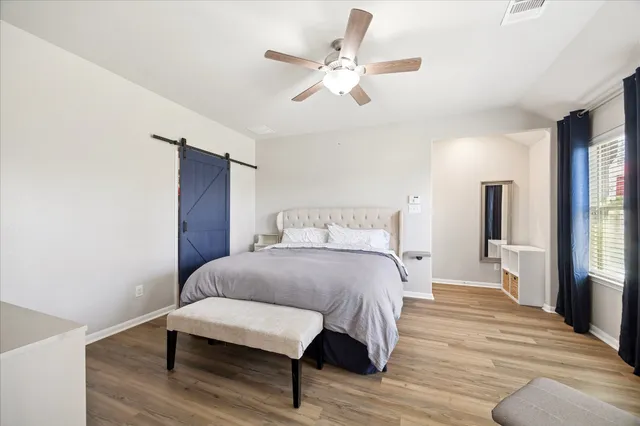 a bedroom with a bed and wooden floor