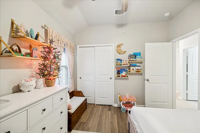 a bedroom with a bed and wooden floor