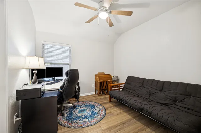 a living room with furniture a rug and a lamp