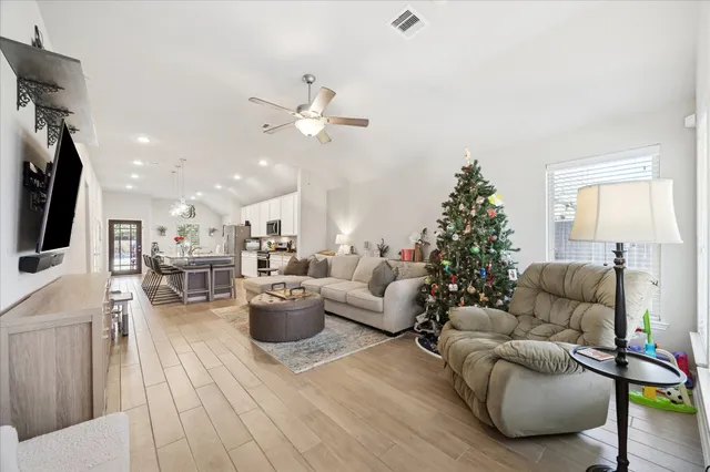 a living room with furniture and a chandelier