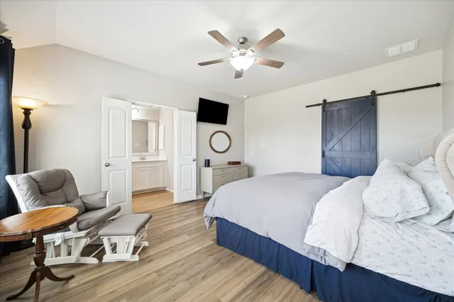 a bedroom with a bed and wooden floor