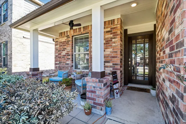 a view of a porch with chairs and backyard