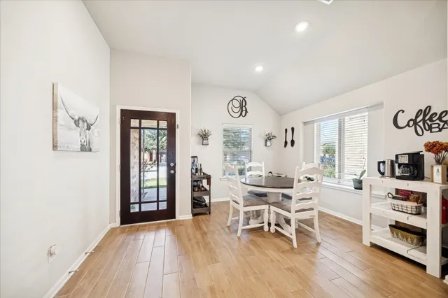 a dining room with furniture and wooden floor