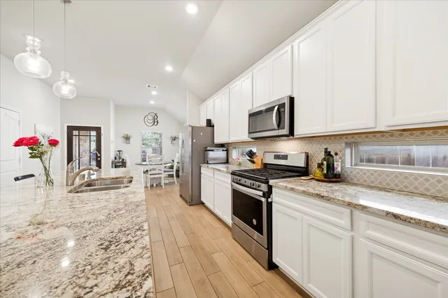 a kitchen with a stove a sink and a refrigerator