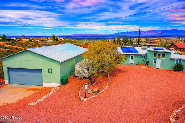 an aerial view of a house with a yard and lake view