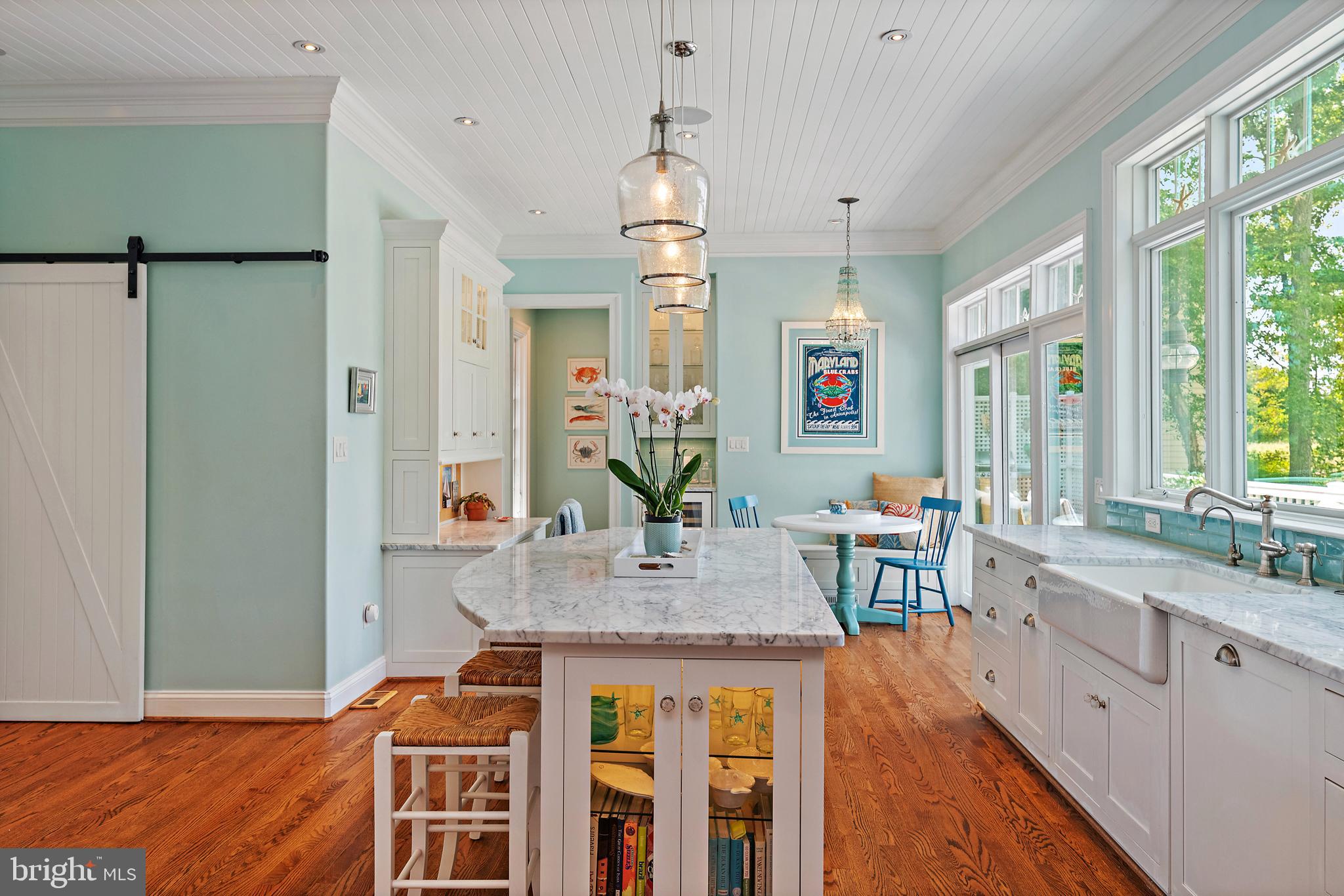 1307 Beachview Road Annapolis, MD 21403 - Photo 31 of 111 a dining hall with granite countertop a sink dishwasher a dining table and chairs with wooden floor