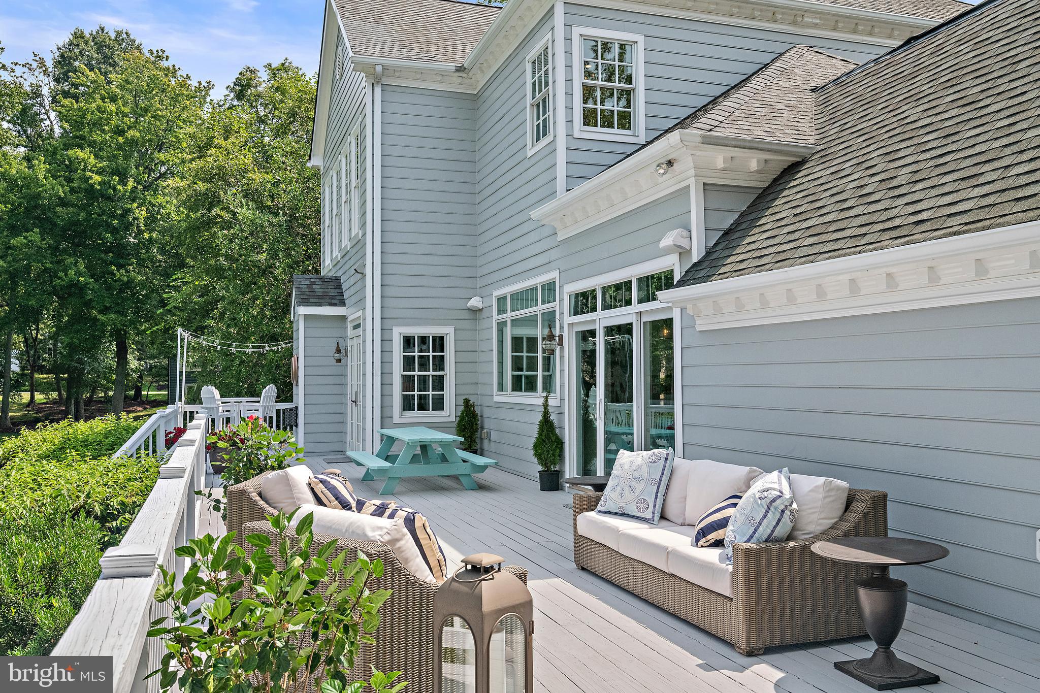 1307 Beachview Road Annapolis, MD 21403 - Photo 9 of 111 a view of a patio with couches table and chairs with wooden floor and fence