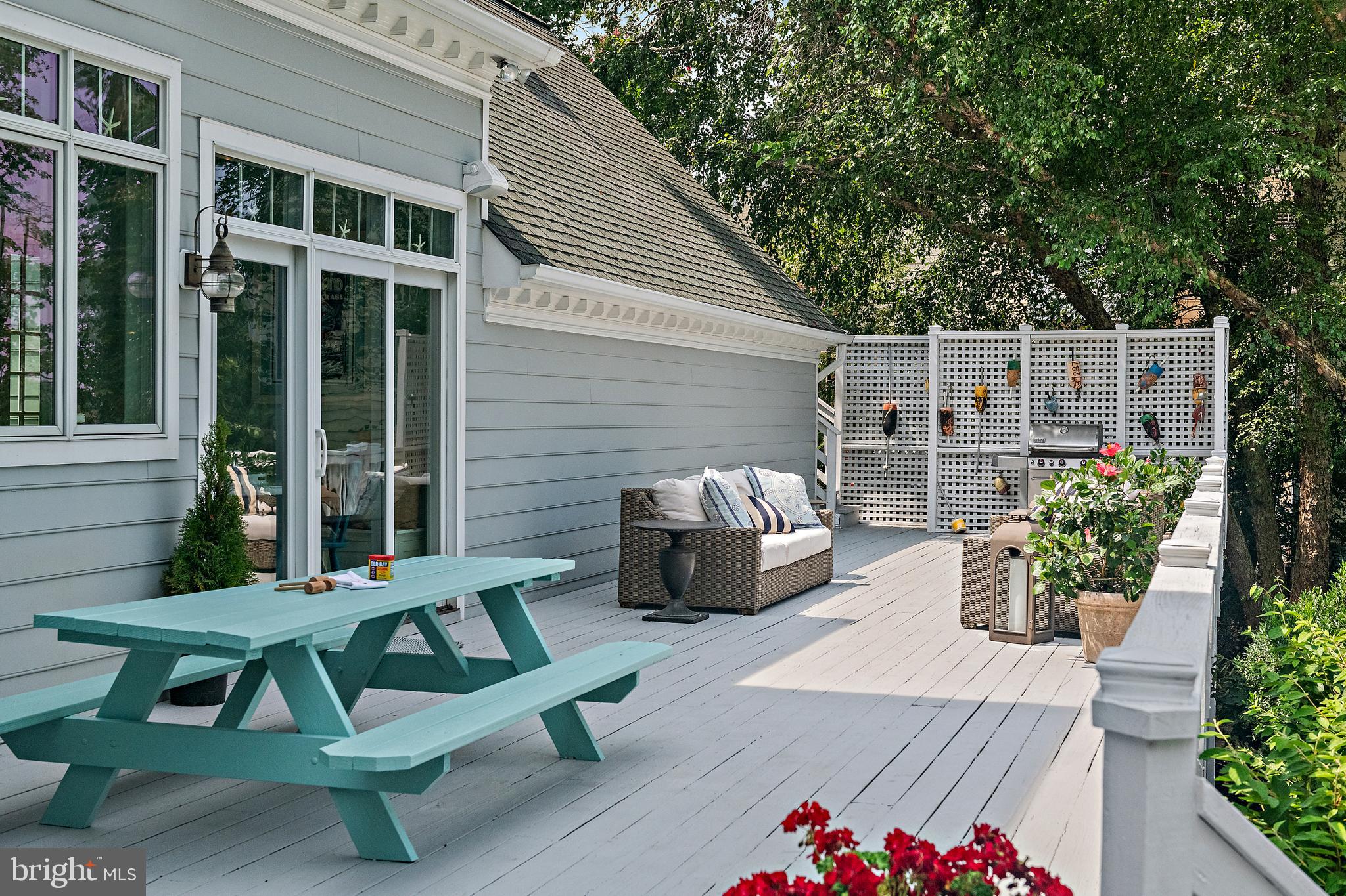 1307 Beachview Road Annapolis, MD 21403 - Photo 91 of 111 a view of a chairs and table in the back yard of the house