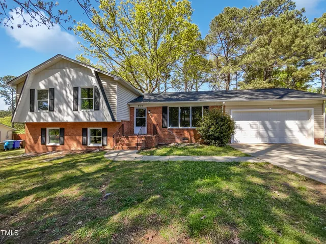 a view of a house with a yard porch and sitting area
