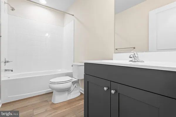 a bathroom with a sink toilet a mirror and shower