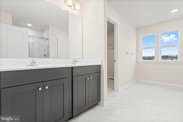 a bathroom with a double vanity sink and mirror
