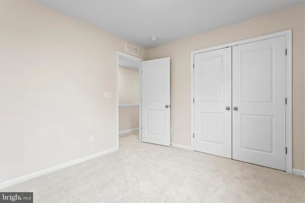 an empty room with closet area