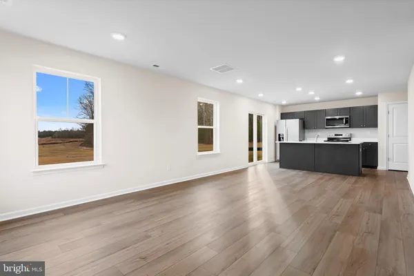 a big room with wooden floor and windows