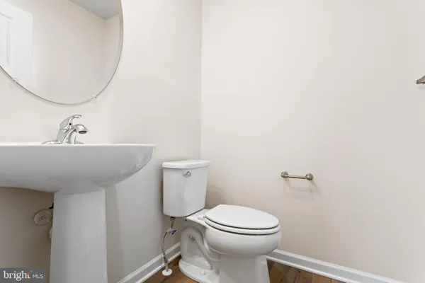 a bathroom with a sink a toilet and mirror