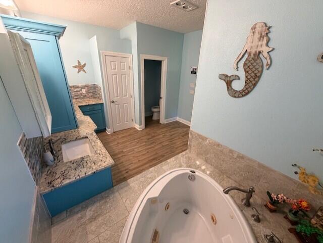 11666 Southwest Meadowlark Circle Stuart, FL 34997 - Photo 19 of 40 a spacious bathroom with a granite countertop tub sink and mirror