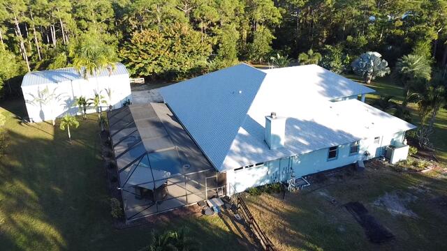 11666 Southwest Meadowlark Circle Stuart, FL 34997 - Photo 25 of 40 an aerial view of a house with a yard