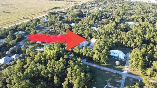 11666 Southwest Meadowlark Circle Stuart, FL 34997 - Photo 3 of 40 an aerial view of residential houses with outdoor space and trees