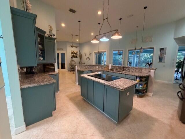 11666 Southwest Meadowlark Circle Stuart, FL 34997 - Photo 33 of 40 a kitchen with stainless steel appliances granite countertop a stove and a refrigerator
