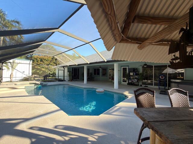 11666 Southwest Meadowlark Circle Stuart, FL 34997 - Photo 38 of 40 a view of a house with swimming pool and sitting area