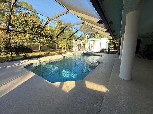 11666 Southwest Meadowlark Circle Stuart, FL 34997 - Photo 4 of 40 a view of a swimming pool with a porch