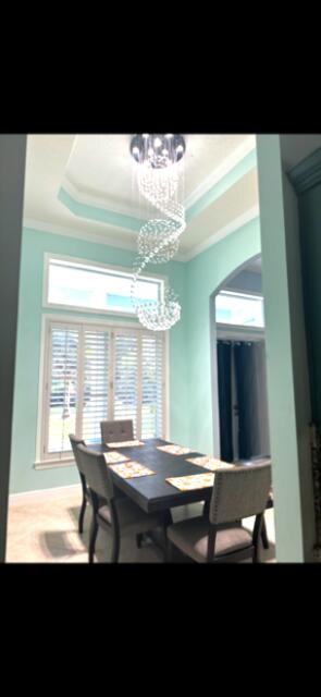 11666 Southwest Meadowlark Circle Stuart, FL 34997 - Photo 8 of 40 a room with a large window and a table