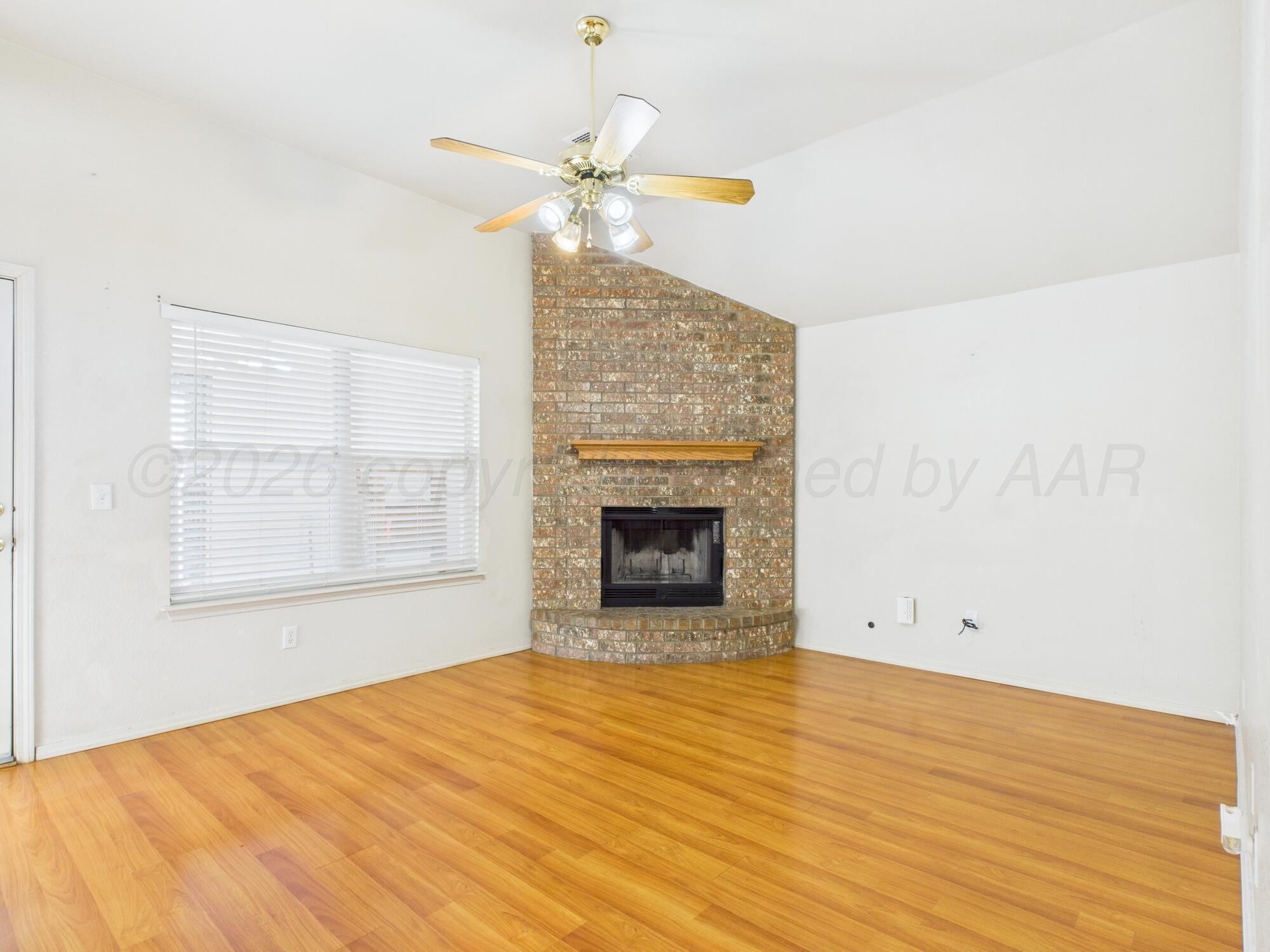 1111 Pikes Peak Drive Amarillo, TX 79110 - Photo 17 of 25 an empty room with wooden floor fireplace and windows