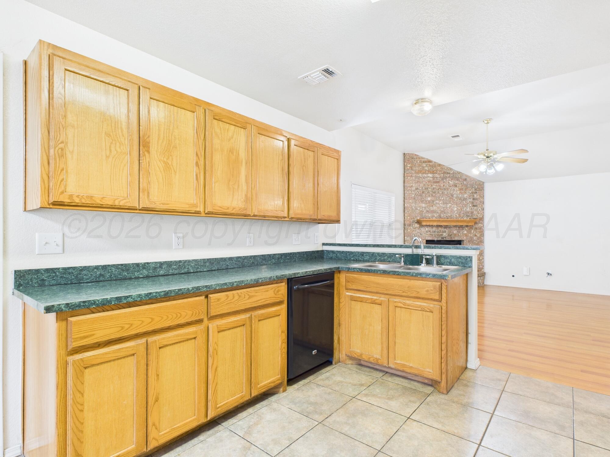 1111 Pikes Peak Drive Amarillo, TX 79110 - Photo 4 of 25 a kitchen with stainless steel appliances granite countertop a stove a sink and a microwave
