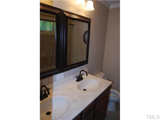 210 Quail Drive Raleigh, NC 27604 - Photo 12 of 17 a bathroom with a sink and a mirror