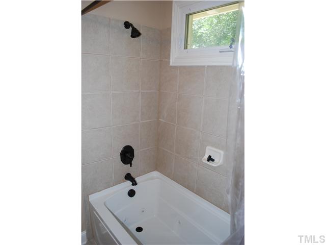 210 Quail Drive Raleigh, NC 27604 - Photo 13 of 17 a bathroom with a tub