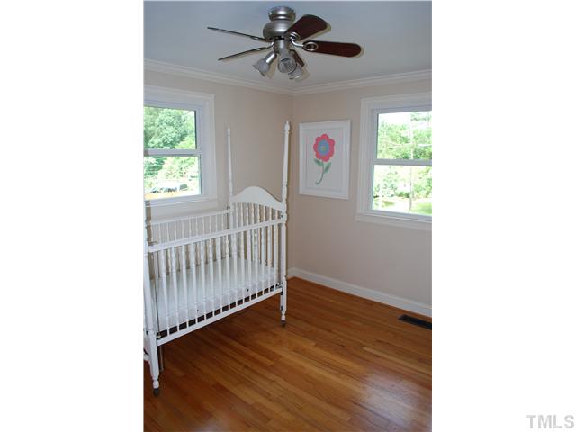 210 Quail Drive Raleigh, NC 27604 - Photo 15 of 17 a view of a room with wooden floor and windows