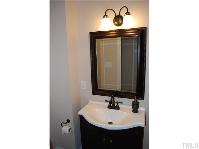 210 Quail Drive Raleigh, NC 27604 - Photo 16 of 17 a bathroom with a sink and a mirror