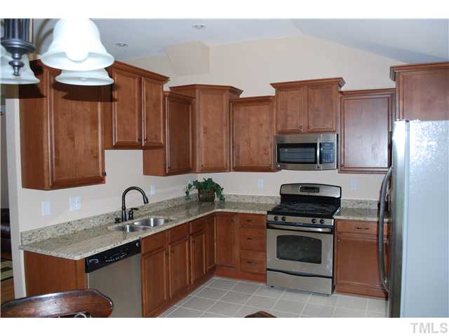 210 Quail Drive Raleigh, NC 27604 - Photo 8 of 17 a kitchen with stainless steel appliances a stove a sink and a microwave