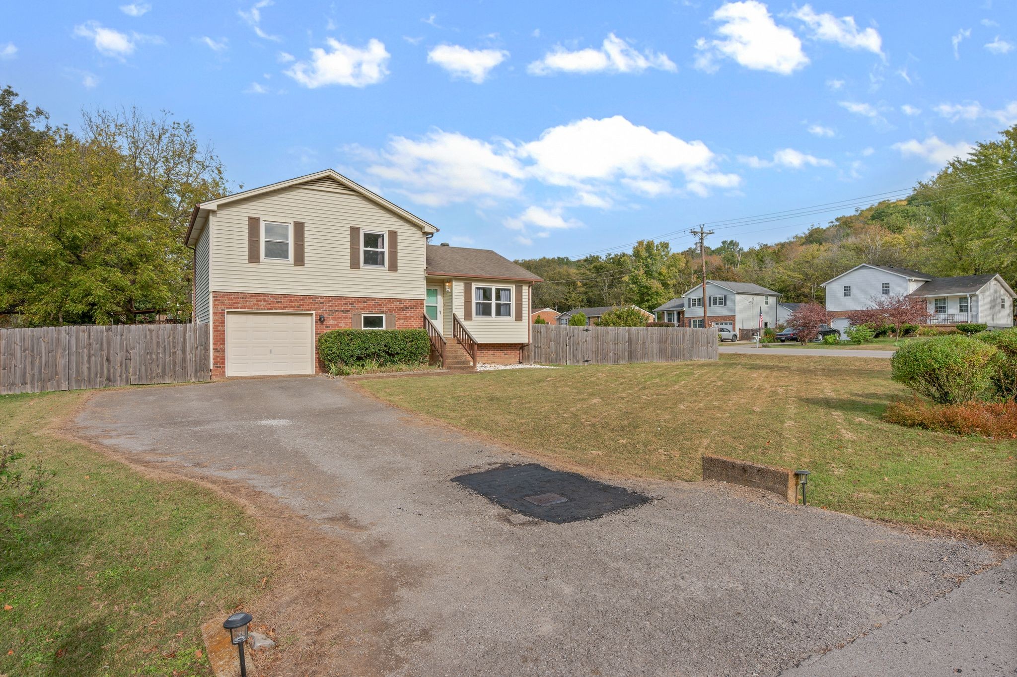 135 Grenadier Drive Franklin, TN 37064 - Photo 2 of 27 a front view of a house with a yard and garage
