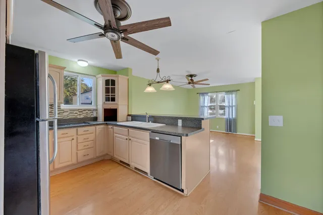 a kitchen with stainless steel appliances granite countertop a sink and cabinets