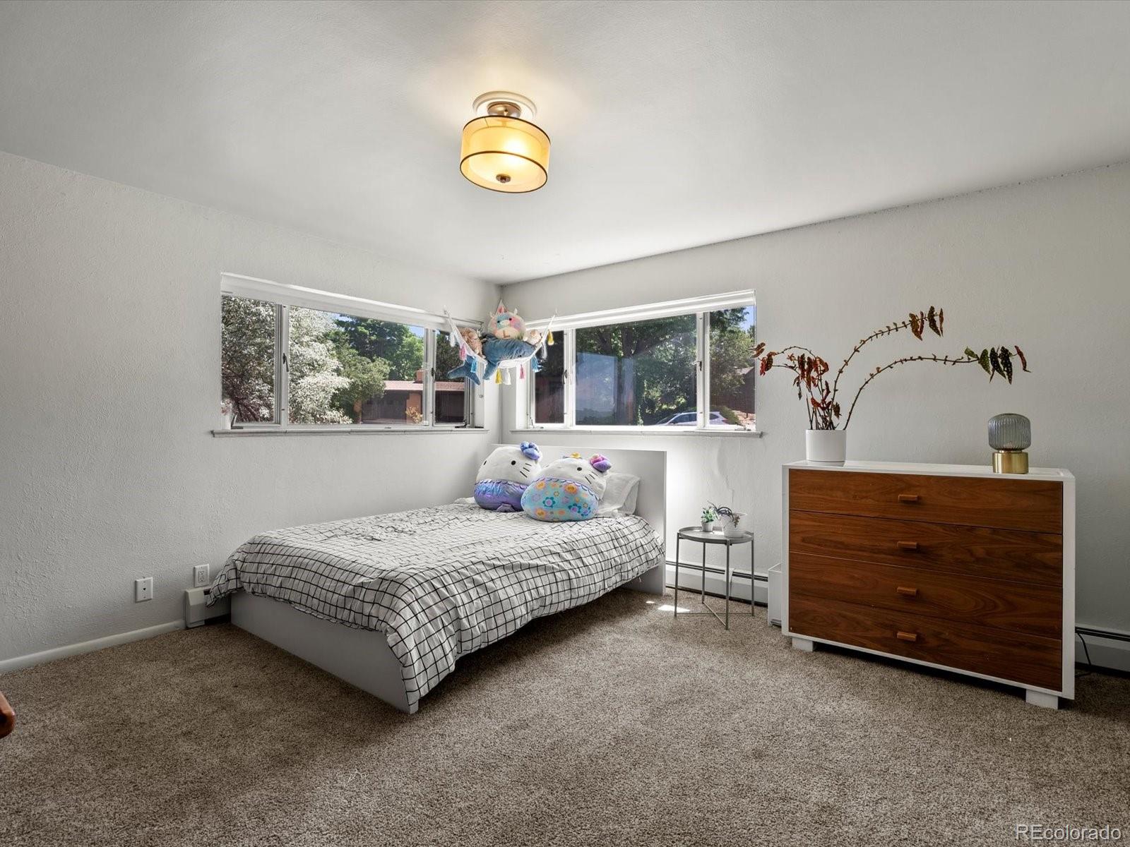 10400 West 35th Place Wheat Ridge, CO 80033 - Photo 13 of 44 a bedroom with a bed and a window