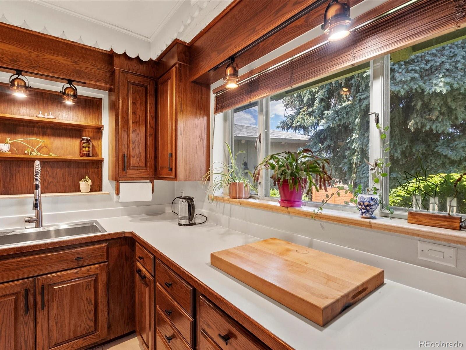 10400 West 35th Place Wheat Ridge, CO 80033 - Photo 19 of 44 a kitchen with a sink and large windows
