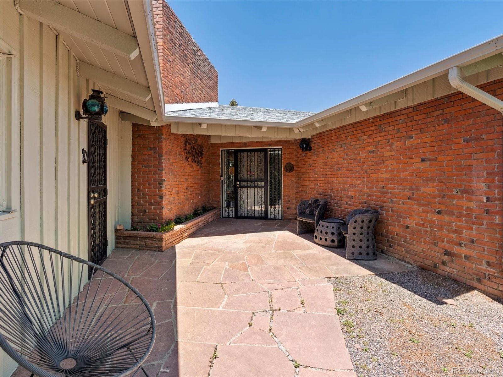 10400 West 35th Place Wheat Ridge, CO 80033 - Photo 2 of 44 a view of a backyard with seating space