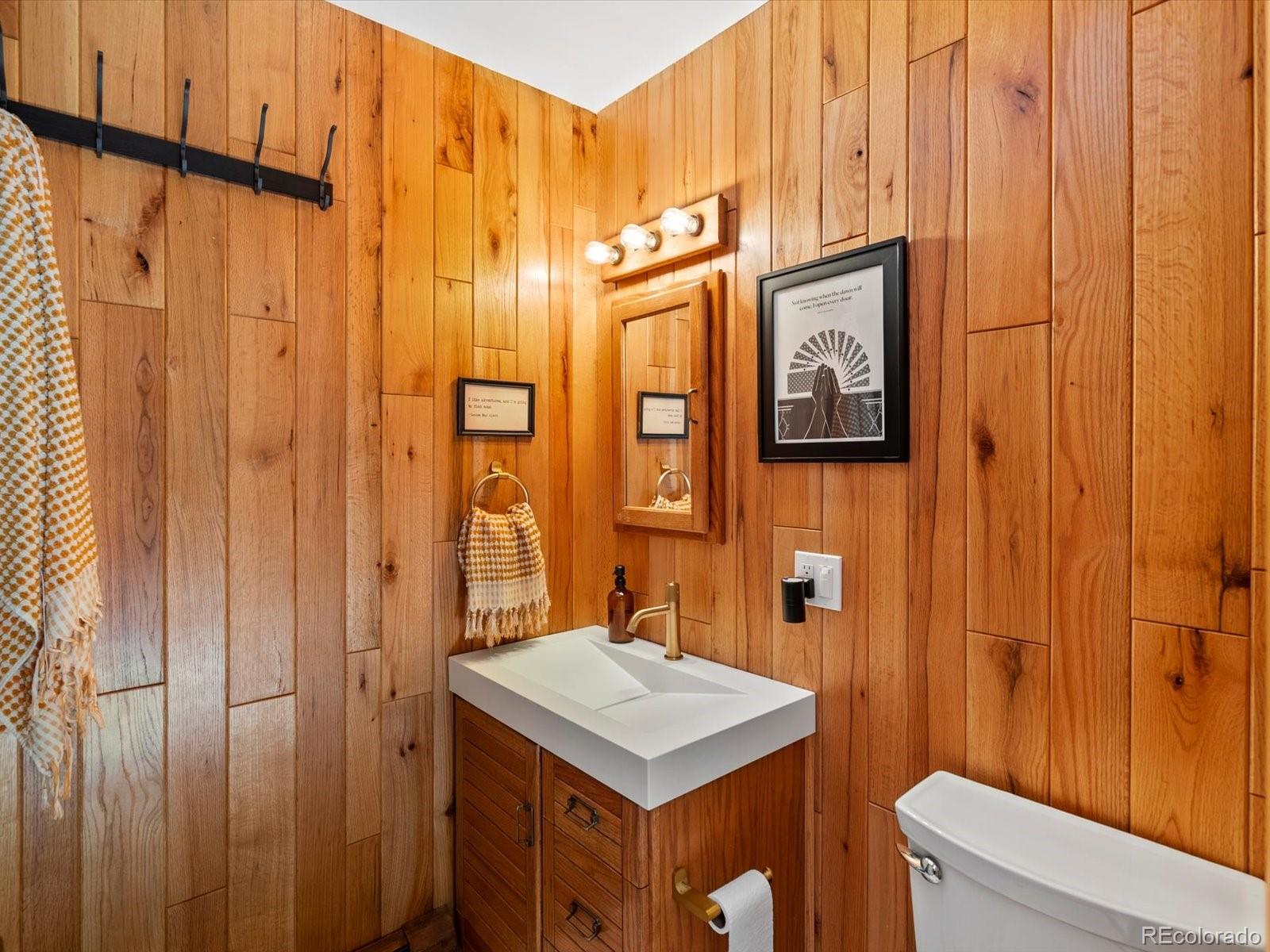 10400 West 35th Place Wheat Ridge, CO 80033 - Photo 25 of 44 a bathroom with a sink a mirror and a shower