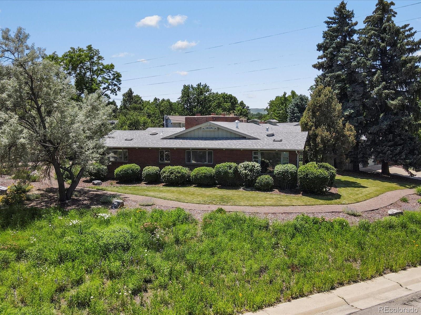 10400 West 35th Place Wheat Ridge, CO 80033 - Photo 41 of 44 a view of a big yard with potted plants and large tree