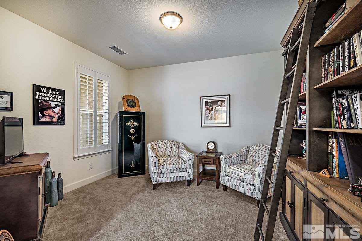 3020 Bull Rider Drive Reno, NV 89521 - Photo 12 of 25 a living room with furniture and a book shelf