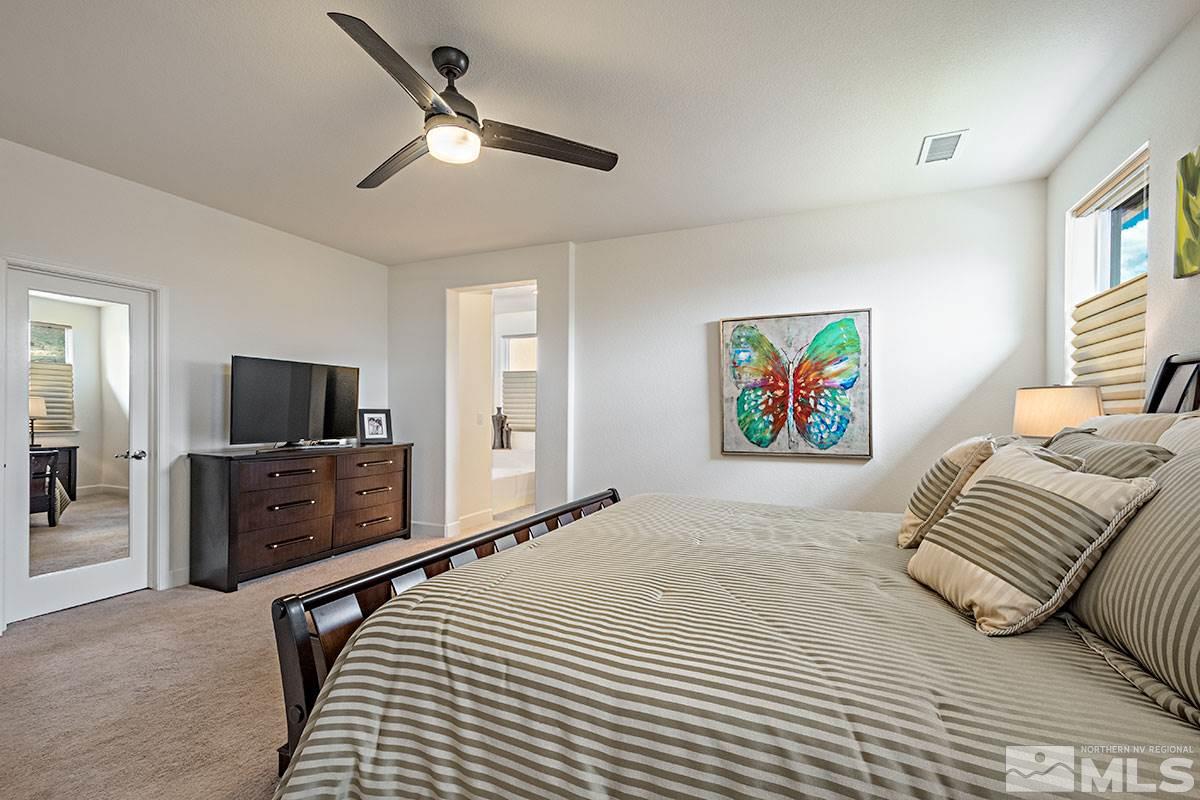 3020 Bull Rider Drive Reno, NV 89521 - Photo 16 of 25 a bedroom with a bed and a flat screen tv