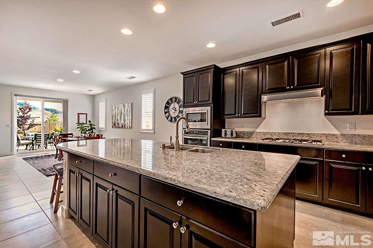 3020 Bull Rider Drive Reno, NV 89521 - Photo 3 of 25 a kitchen with granite countertop stainless steel appliances and sink