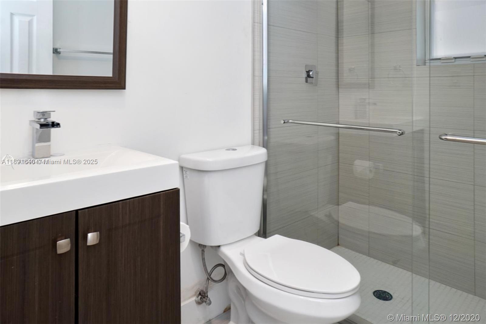 2601 Northwest 1st Avenue, Unit 6 Miami, FL 33127 - Photo 11 of 11 a bathroom with a sink a toilet and shower