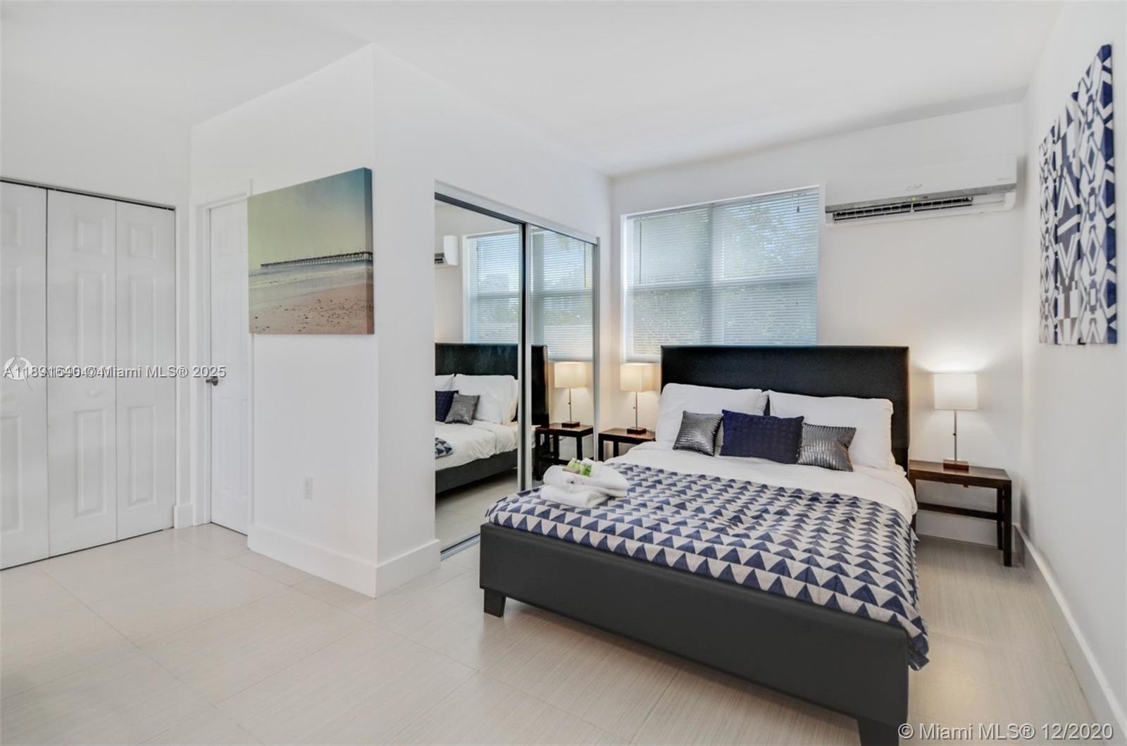 2601 Northwest 1st Avenue, Unit 6 Miami, FL 33127 - Photo 7 of 11 a bedroom with a bed and a window